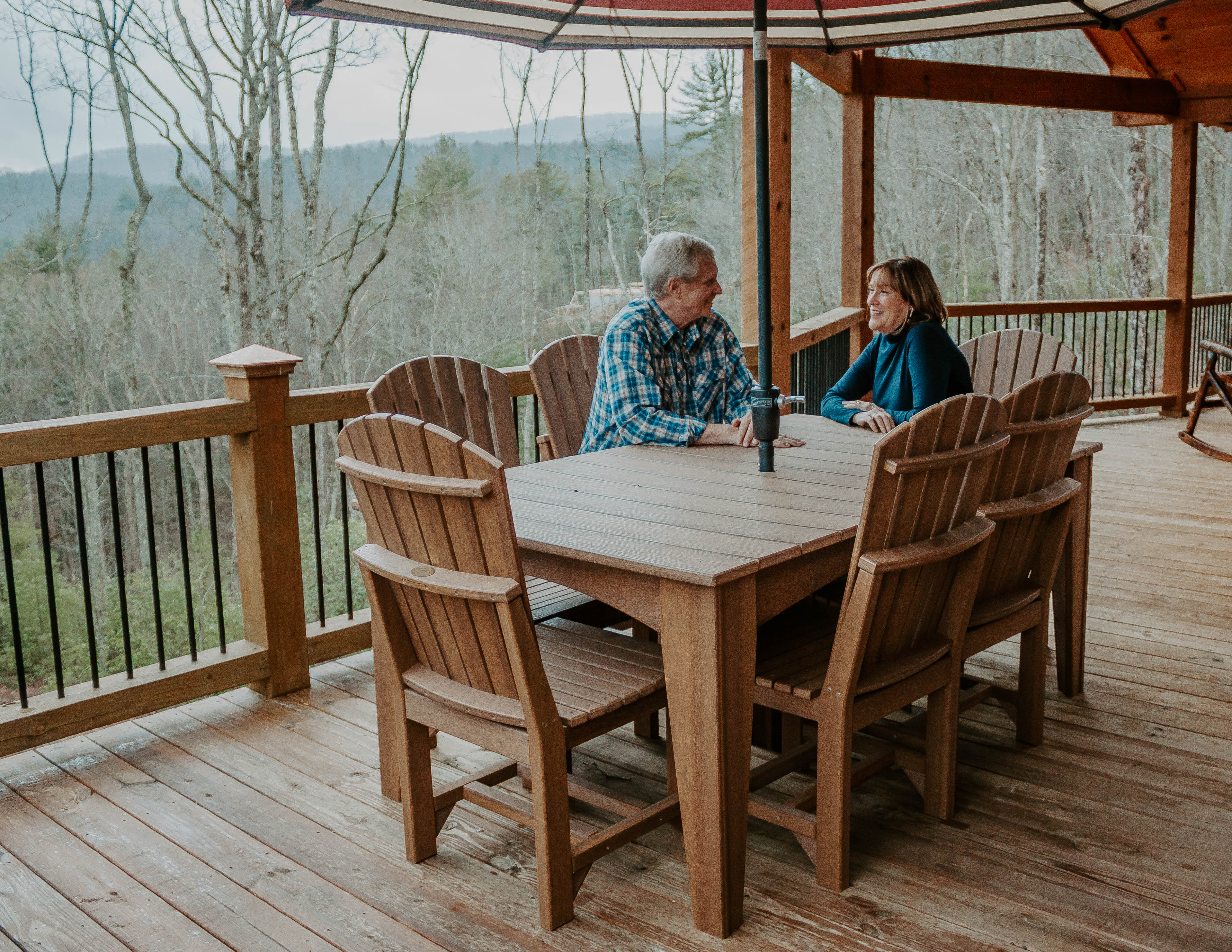 Couple Sitting at Outdoor Poly Dining Furniture Table Outside