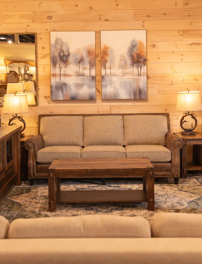 modern rustic sofa with leather on the frame and fabric seat cushions and backs