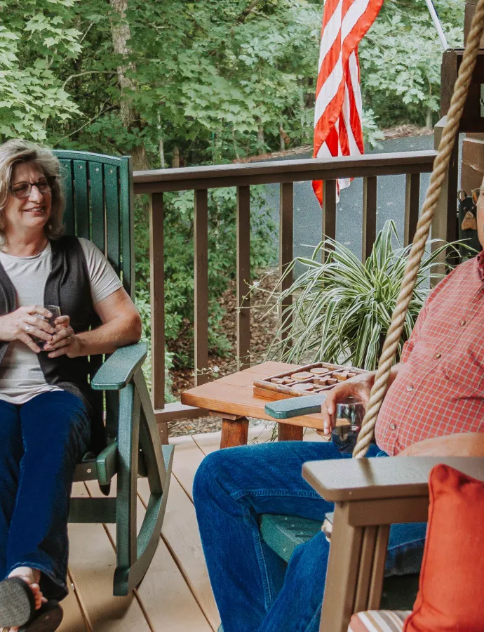 Couple Sitting at Outdoor Swing Green Poly Rockers