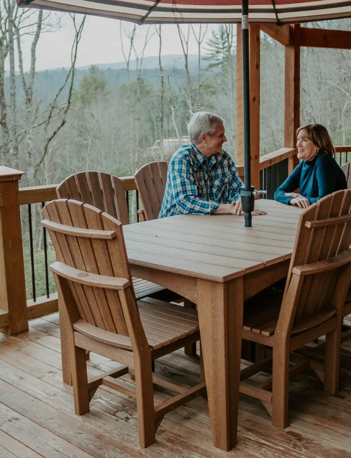 Couple Sitting at Outdoor Poly Dining Furniture Table Outside