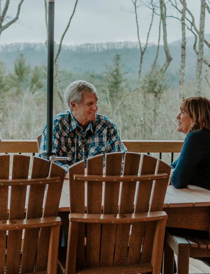 Couple Sitting Outside at Poly Furniture Dining Table