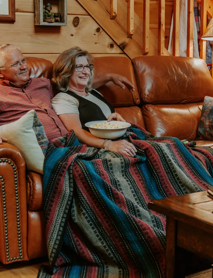 Couple Sitting on Leather Reclining Couch