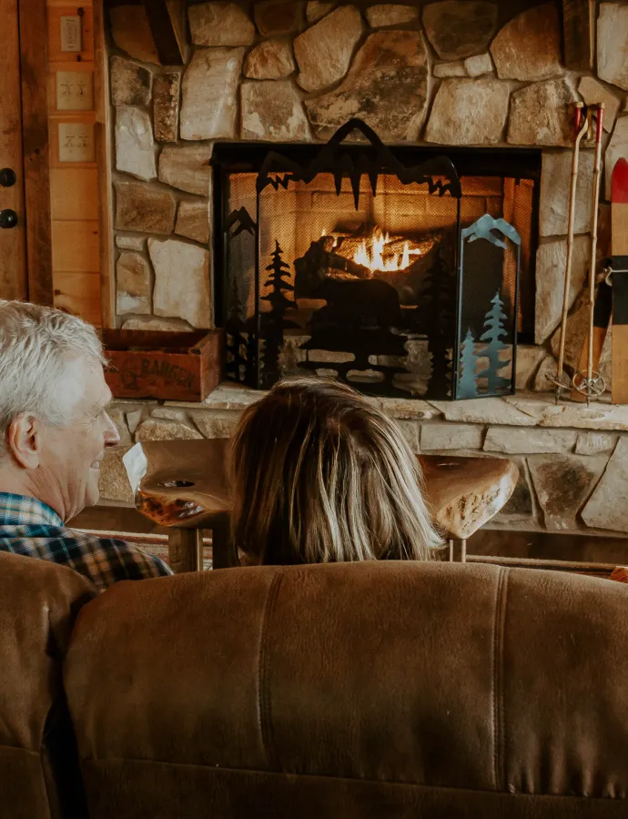 Couple on Leather Couch by Fireplace