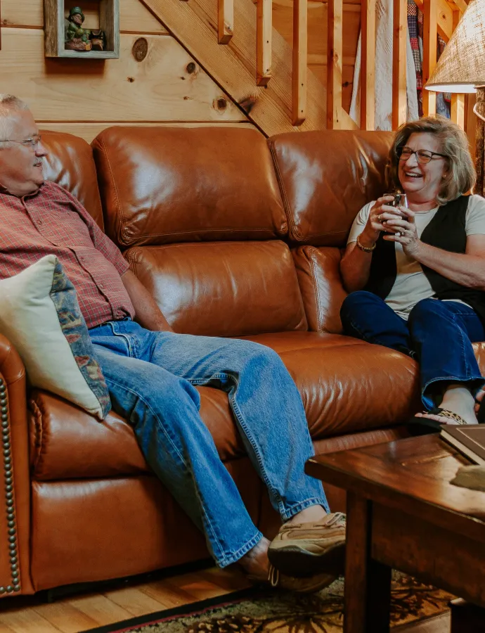 Couple Sitting on Leather Reclining Couch