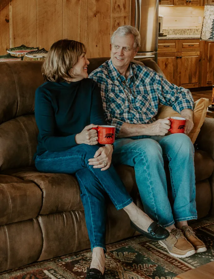 Couple Sitting on Leather Reclining Couch