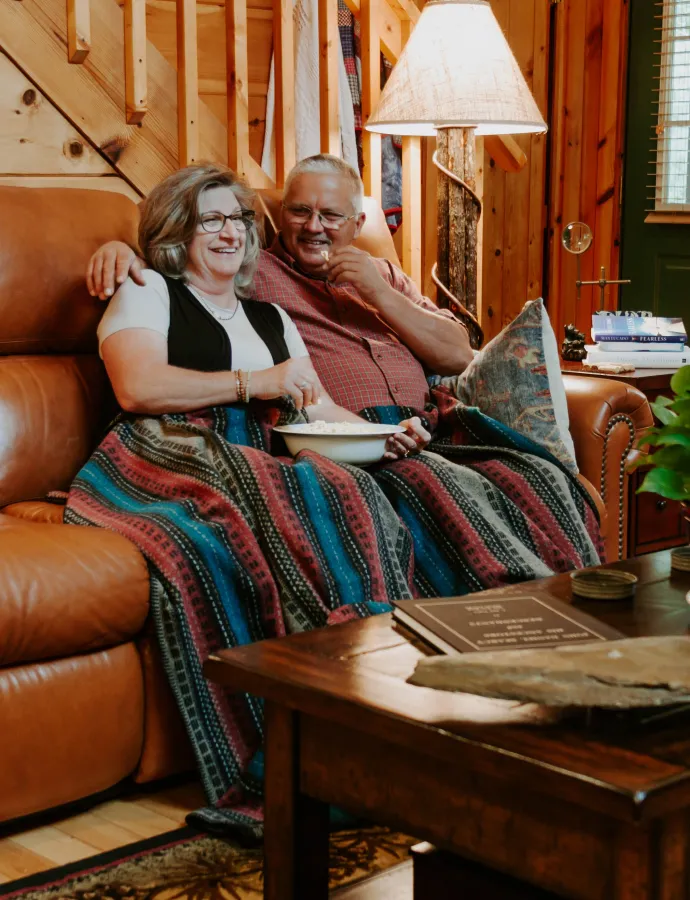 Couple Sitting on Leather Reclining Couch