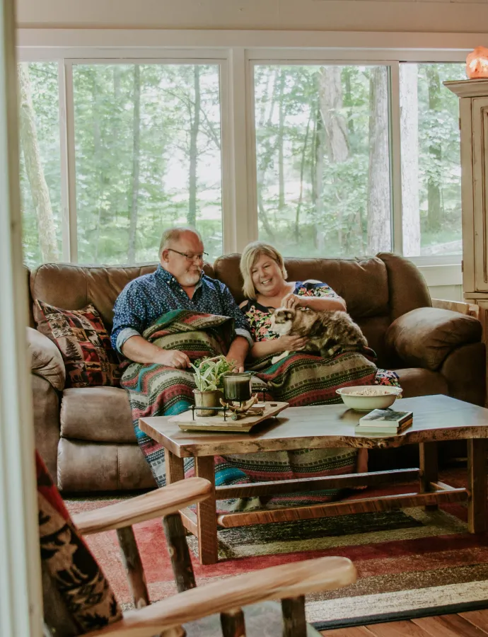 Couple Sitting on Leather Reclining Couch