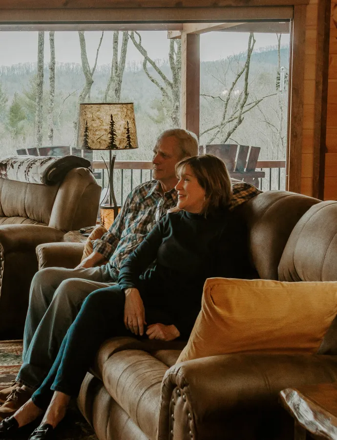 Couple Sitting on Leather Reclining Couch