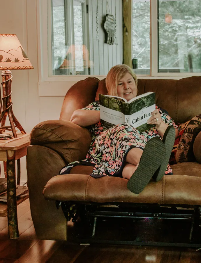 Woman in Leather Reclining Chair Reading in Cabin